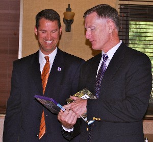 In September, Jerry Stidham (r), chapter president, presents Marion with a book and an Xbox game.